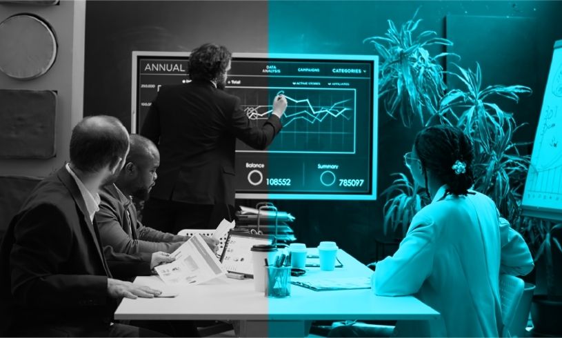 Satış grafiklerini inceleyen bir yönetici ve arkasında dinamik, motive olmuş satış ekibi; hedef odaklılığı, rekor performansı ve ekip başarısını simgeleyen görsel.